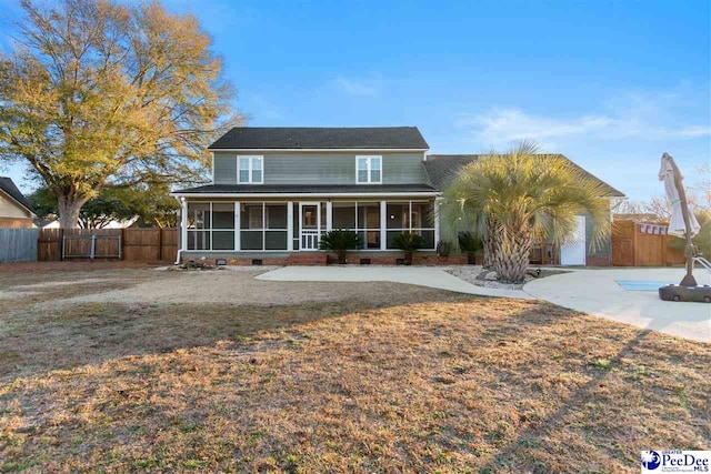 view of front of home with a front lawn and a sunroom