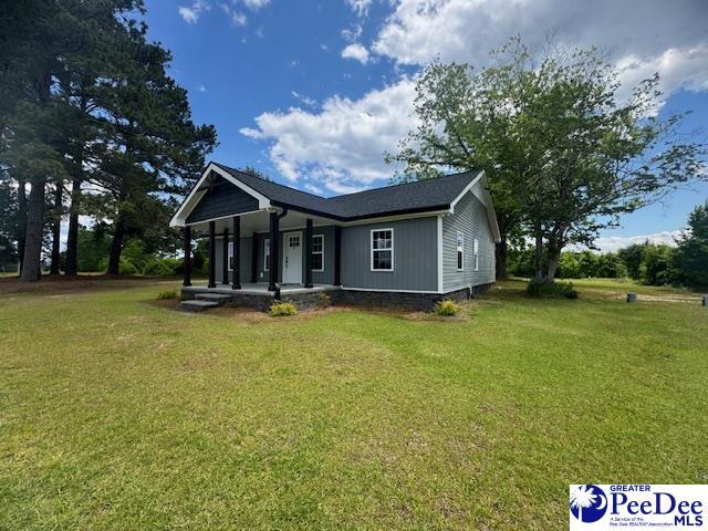 view of front of house featuring a front yard and covered porch