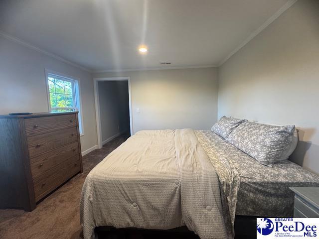 carpeted bedroom with crown molding, baseboards, and recessed lighting