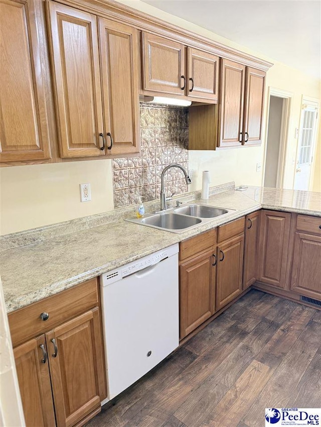1801 E Howe Springs Rd, Florence, SC 29505 - kitchen featuring white dishwasher, dark wood finished floors, backsplash, brown cabinetry, and light stone countertops
