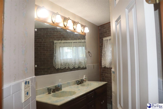 25560 Hwy 151, Mcbee, SC 29101 - bathroom featuring double vanity, a textured ceiling, tile walls, and a sink