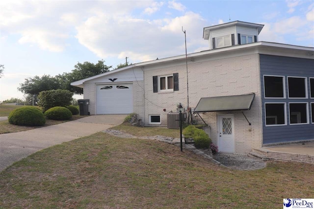 25560 Hwy 151, Mcbee, SC 29101 - view of home's exterior featuring a lawn, brick siding, an attached garage, central air condition unit, and driveway