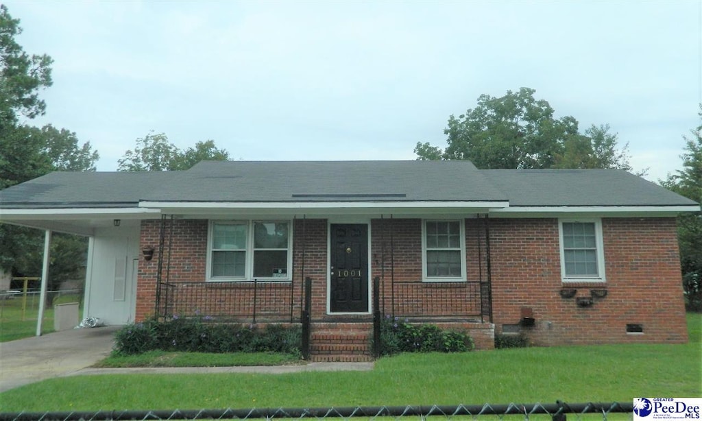 view of front facade with a carport and a front yard