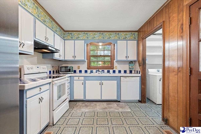 1216 Arrowood Dr, Florence, SC 29501 - kitchen with white appliances, under cabinet range hood, washer / clothes dryer, tile countertops, and white cabinetry