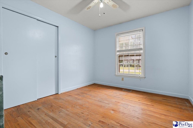 1216 Arrowood Dr, Florence, SC 29501 - unfurnished bedroom featuring light wood-style floors, a closet, baseboards, and a ceiling fan