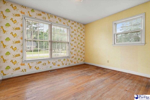 1216 Arrowood Dr, Florence, SC 29501 - spare room with light wood-type flooring, baseboards, and wallpapered walls