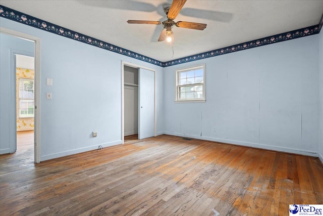 1216 Arrowood Dr, Florence, SC 29501 - unfurnished bedroom with wood finished floors, baseboards, a closet, and a ceiling fan