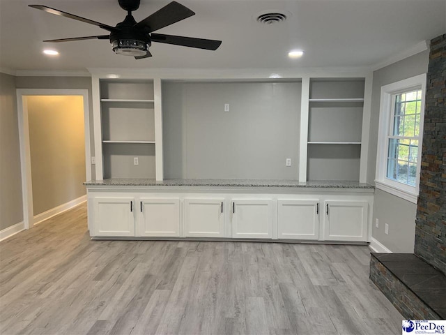 interior space with built in shelves, ceiling fan, ornamental molding, and light hardwood / wood-style floors