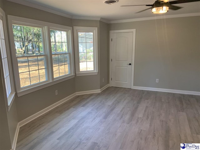 spare room featuring crown molding, ceiling fan, and light hardwood / wood-style flooring