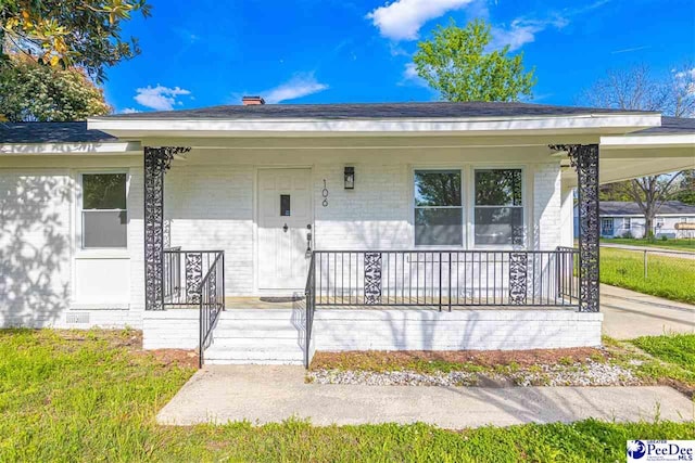 view of front of property featuring a porch and brick siding