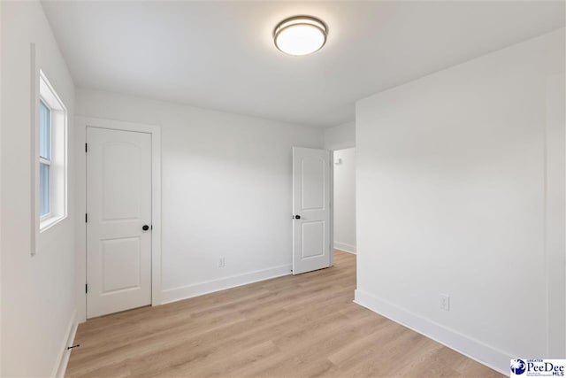 unfurnished room featuring light wood-style floors and baseboards