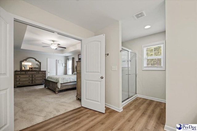 1757 Lake Wateree Dr, Florence, SC 29501 - bedroom featuring a tray ceiling, light wood finished floors, a ceiling fan, and recessed lighting