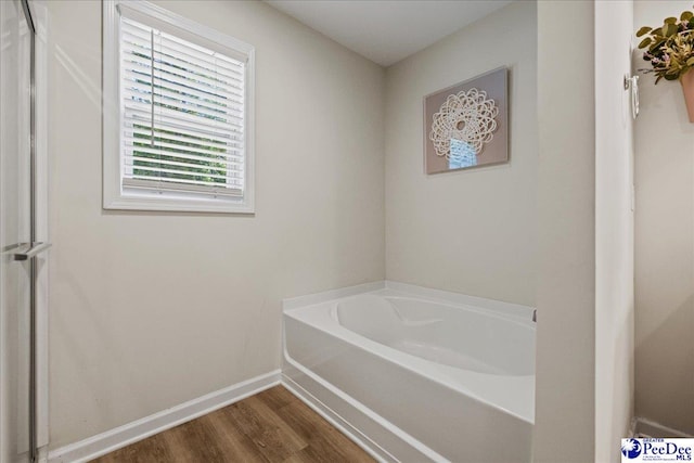 1757 Lake Wateree Dr, Florence, SC 29501 - bathroom featuring a bath and wood finished floors