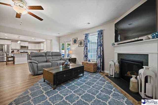 1757 Lake Wateree Dr, Florence, SC 29501 - living area with a ceiling fan, dark wood finished floors, a fireplace with flush hearth, and recessed lighting