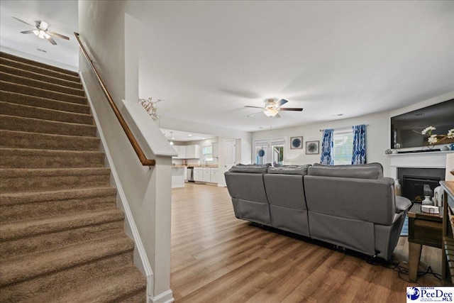 1757 Lake Wateree Dr, Florence, SC 29501 - living room with ceiling fan, wood finished floors, stairway, and plenty of natural light
