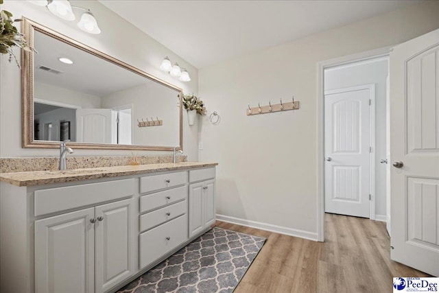 1757 Lake Wateree Dr, Florence, SC 29501 - full bathroom featuring wood finished floors and double vanity