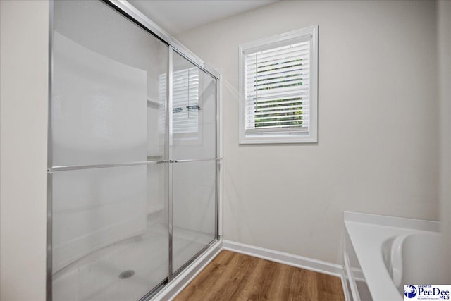 1757 Lake Wateree Dr, Florence, SC 29501 - full bath featuring a shower with door, wood finished floors, and a garden tub