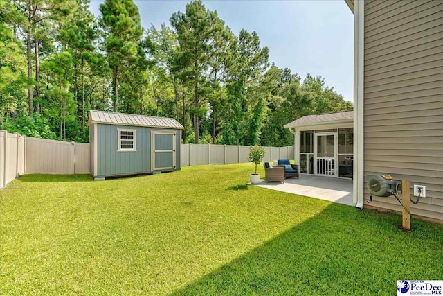 1757 Lake Wateree Dr, Florence, SC 29501 - fenced backyard featuring a patio area, a storage unit, a sunroom, and view of scattered trees