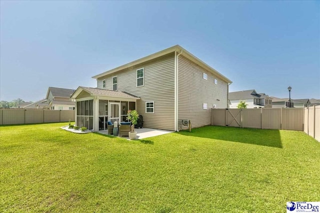 1757 Lake Wateree Dr, Florence, SC 29501 - back of property with a sunroom, a fenced backyard, and a patio
