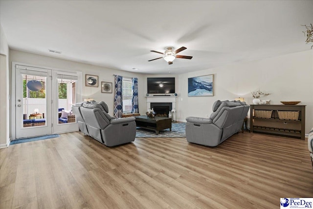 1757 Lake Wateree Dr, Florence, SC 29501 - living room featuring light wood-type flooring, a ceiling fan, and a fireplace