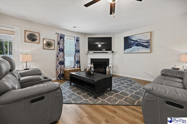 1757 Lake Wateree Dr, Florence, SC 29501 - living area featuring ceiling fan, wood finished floors, and a glass covered fireplace