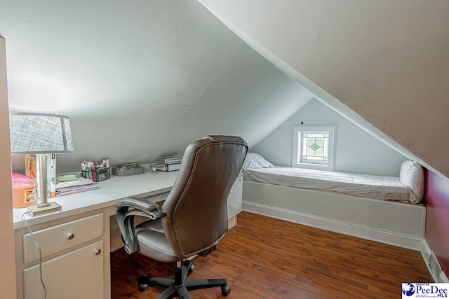 home office featuring vaulted ceiling and wood finished floors