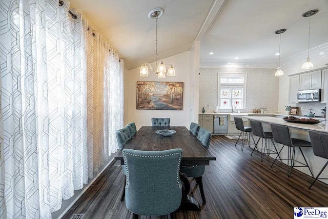 dining room featuring crown molding, dark wood-style flooring, and a notable chandelier