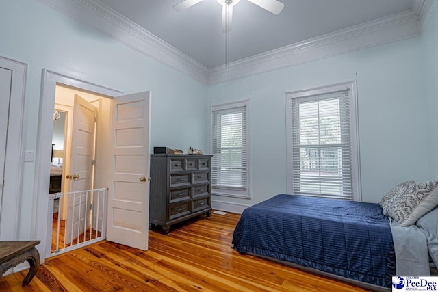 bedroom with crown molding, ceiling fan, and wood finished floors