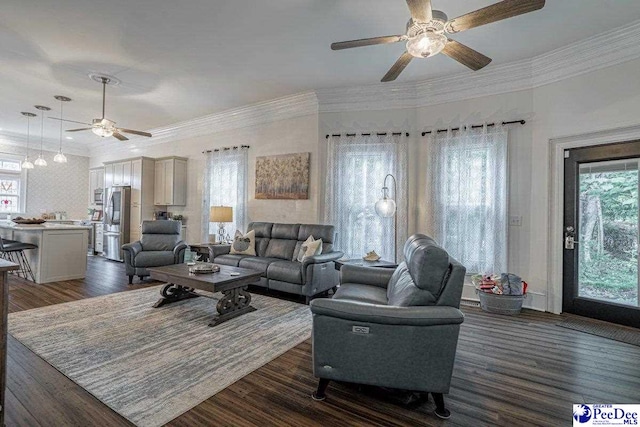 living room featuring wood finished floors, plenty of natural light, ornamental molding, and ceiling fan