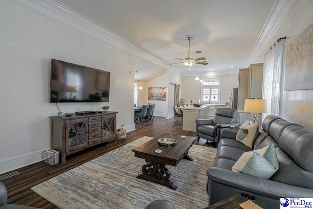 living room with dark wood-type flooring, a ceiling fan, ornamental molding, and baseboards