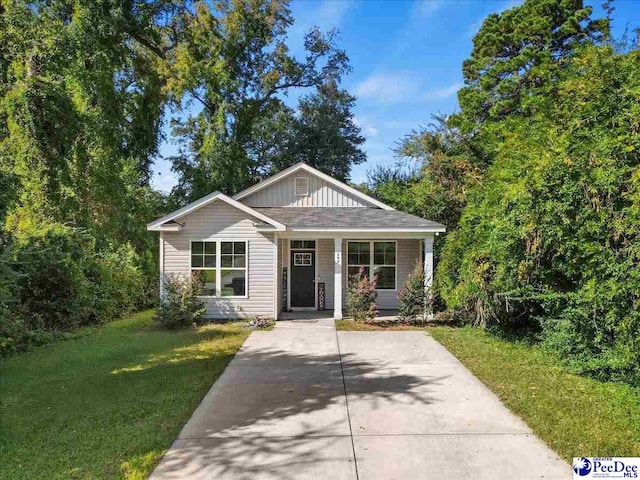 bungalow-style home with a front lawn