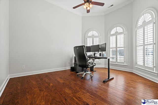 home office with a wealth of natural light, visible vents, crown molding, and wood finished floors