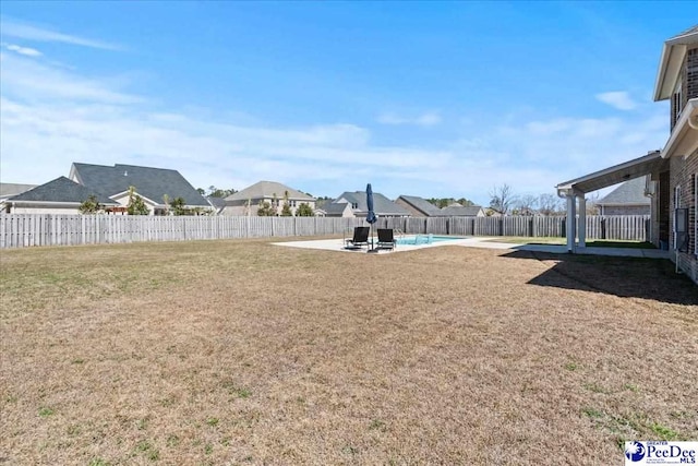 view of yard featuring a fenced backyard, a fenced in pool, and a patio