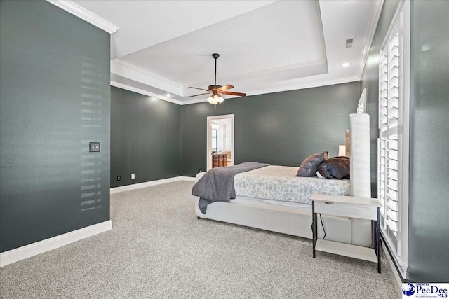 bedroom featuring a tray ceiling, carpet flooring, crown molding, and baseboards