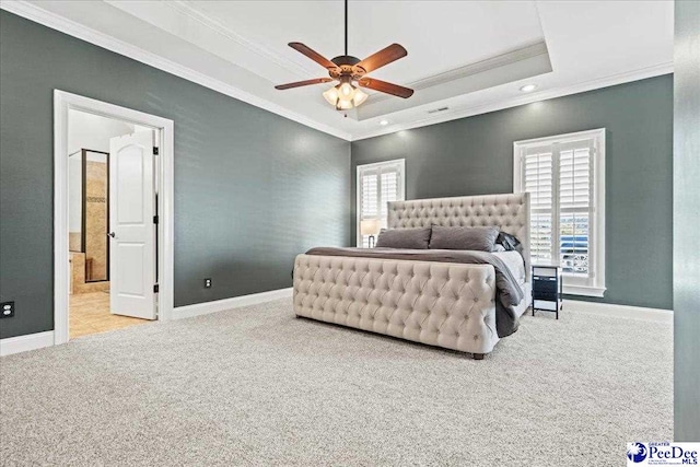 bedroom featuring multiple windows, crown molding, carpet, and a tray ceiling