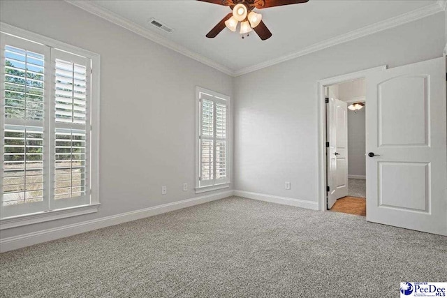 unfurnished bedroom with visible vents, baseboards, carpet, and ornamental molding