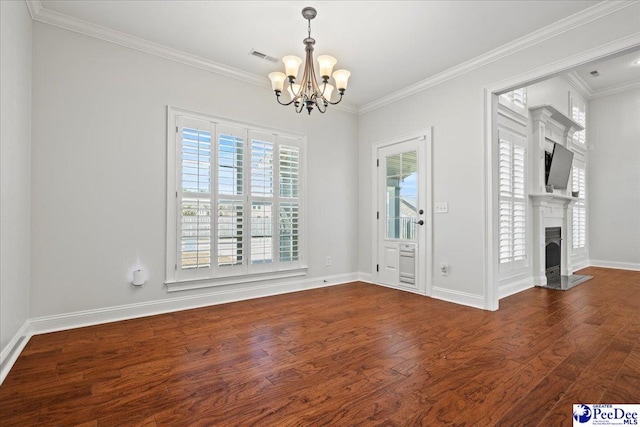 interior space with ornamental molding, a fireplace, baseboards, and wood finished floors