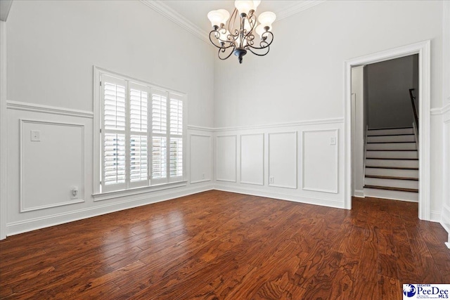 unfurnished room featuring stairway, a decorative wall, ornamental molding, and a chandelier