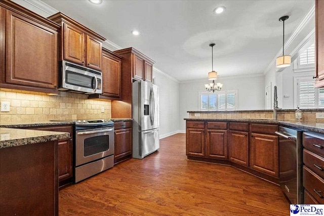 kitchen with dark wood-style floors, appliances with stainless steel finishes, crown molding, tasteful backsplash, and a wealth of natural light