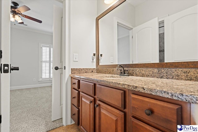 bathroom with a ceiling fan, vanity, and crown molding