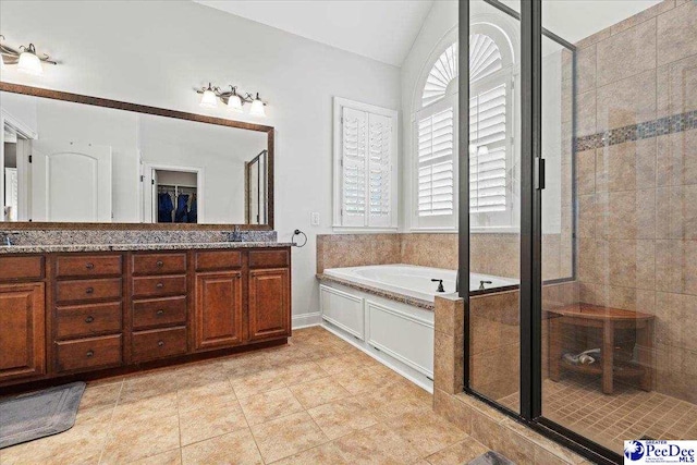 bathroom with lofted ceiling, double vanity, a stall shower, tile patterned flooring, and a bath