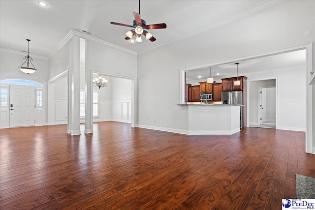 unfurnished living room with ceiling fan, visible vents, dark wood-style floors, and crown molding