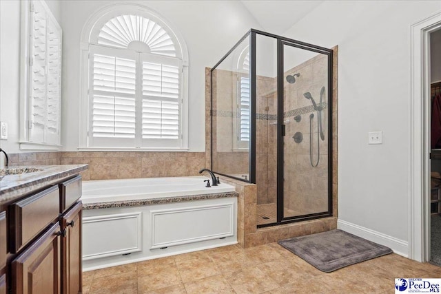 bathroom featuring tile patterned flooring, a shower stall, a bath, and vanity