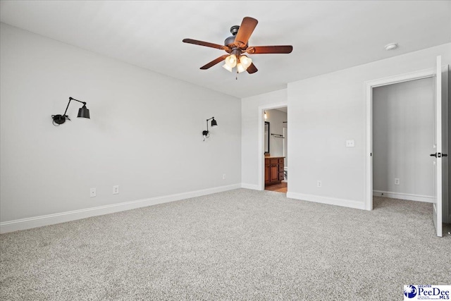 unfurnished bedroom with ensuite bath, ceiling fan, baseboards, and carpet