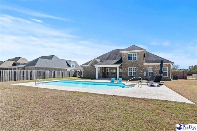 view of swimming pool with central air condition unit, a lawn, a patio, and a fenced in pool