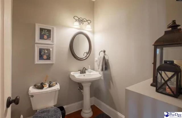 3438 Hammock Ct, Florence, SC 29501 - half bath featuring toilet and baseboards
