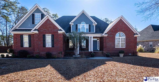 3438 Hammock Ct, Florence, SC 29501 - view of front facade with a porch, brick siding, and roof with shingles