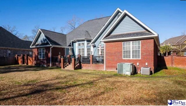 3438 Hammock Ct, Florence, SC 29501 - rear view of property featuring brick siding, a yard, and central AC