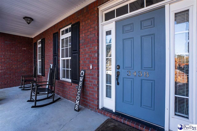 3438 Hammock Ct, Florence, SC 29501 - view of exterior entry featuring brick siding and covered porch