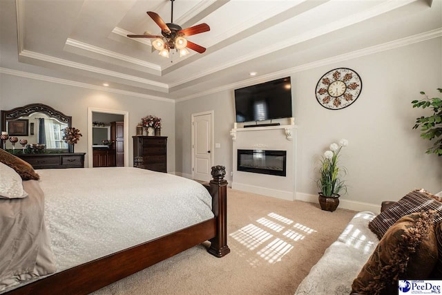 3438 Hammock Ct, Florence, SC 29501 - bedroom with a tray ceiling, a glass covered fireplace, ornamental molding, and light carpet